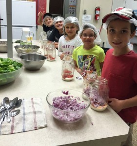 Fun in a community kitchen: Kristen Pouru and Seok Koon Chin from Our Kids Count help Marley and Garon prep and cook a healthy meal. In the last six months, 178 different kitchen programs have supported children and adults while they learn the skills and joys of cooking.
