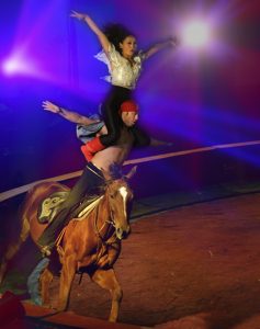 Nur Jamal, top, and Ulanbek Kambarov, bottom, ride a horse during a performance of Jordan's Shrine Circus at the Taylor County Expo Center, Reporter-News photo by Nellie Doneva